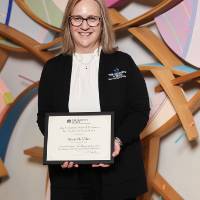 Sheri smiling with her award